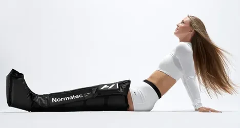 A woman wearing normatec technology
