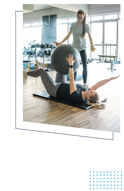 A patient on the group stretching while a practitioner guides them through the exercise