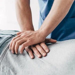 A chiropractor adjusting a patient